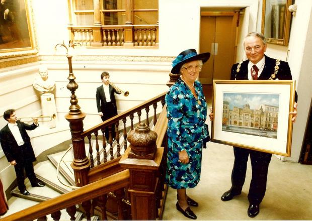Glasgow Times: Lady Marion FraserLady Fraser with the Deacon Convener of the Trades of Glasgow, Kenneth Sandford, being enrolled as an honorary guild sister and burgess of Glasgow of the rank of Hammerman. She also received the first print of a commemorative painting.